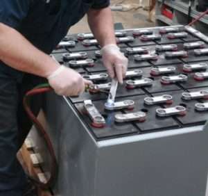 man repairing forklift battery